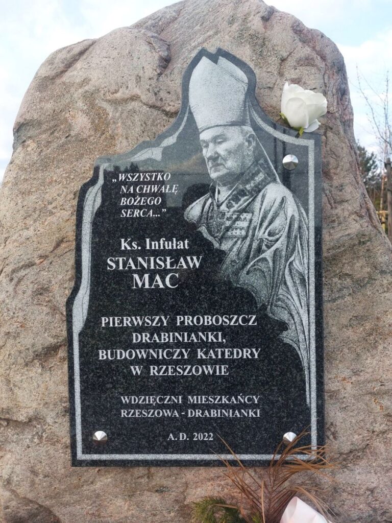 A granite commemorative plaque on memorial stone for Father Stanisław Mac